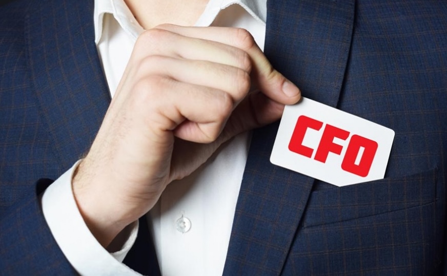 Business Building – CFO man met kaartje CFO in rode letter borstzak blauw pak